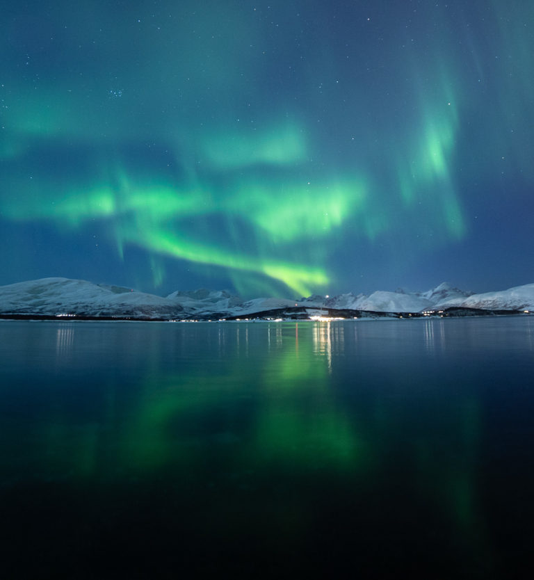 The mountain peaks are often silhouetted by the lights in the far west © William Copeland