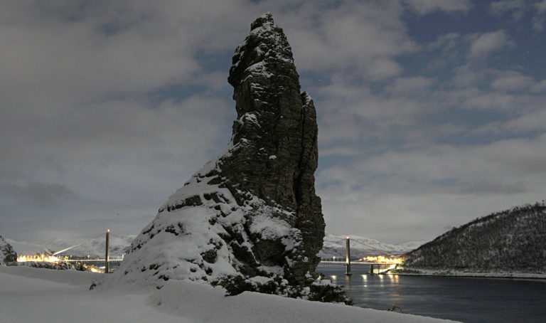 The "stallo" at Kvalsund. A stallo is a troll or giant in Sami mythology. The bridge in the back connects Hammerfest with the mainland @ Bjørn-Owe Holmberg