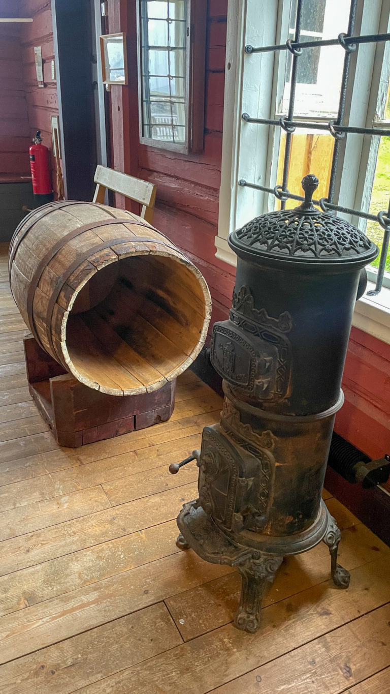 Oven and molasses barrel in the shop. The oven would keep the molasses warm, so that it could be sold. Hemmestad brygge, Kvæfjord © Knut Hansvold
