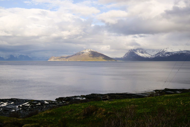 Haukøya island in the sun, while rain showers play with the peaks of the Kvænangstindan, seen from Engnes © Knut Hansvold