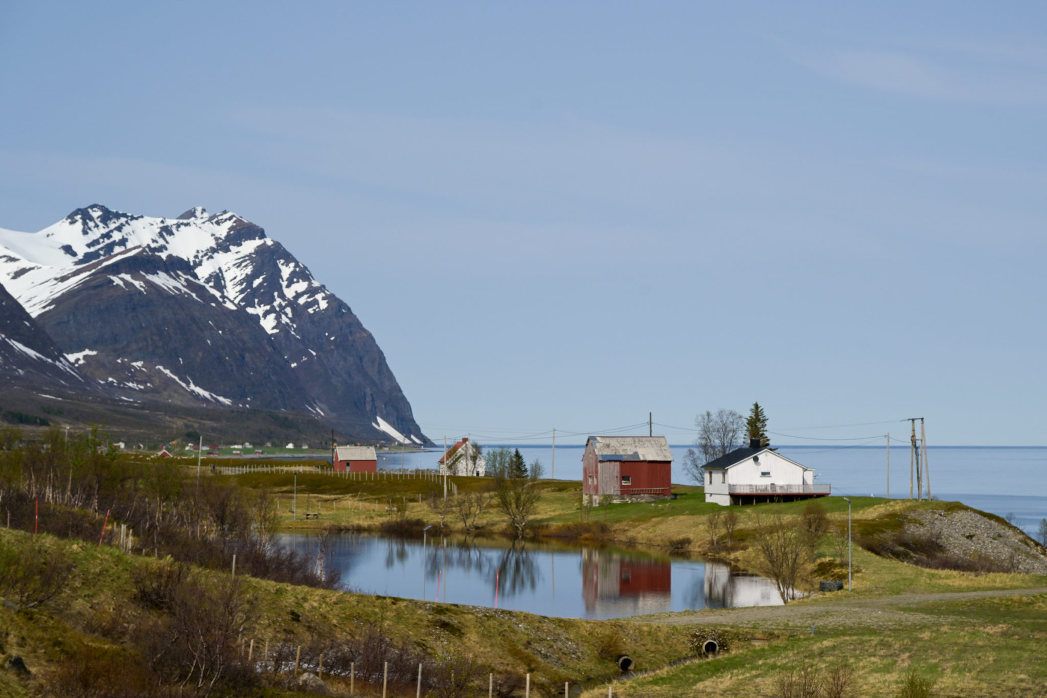 Houses and farms on Arnøya island. In the background of the image lies the open Atlantic © Knut Hansvold