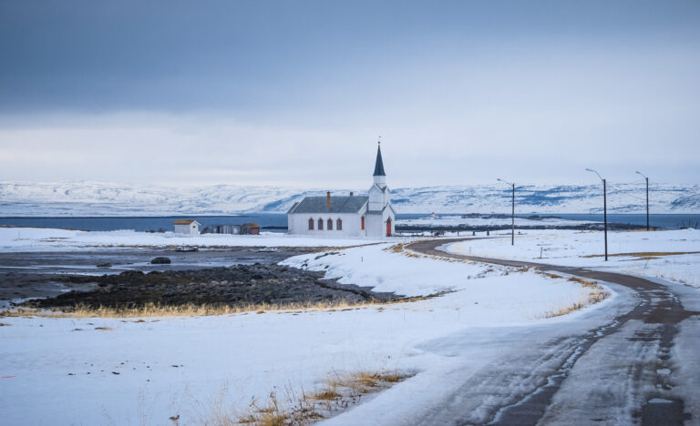 Nesseby Church along the Norwegian Scenic Route Varanger dates from 1858, survived the war, and is visible from afar on the headland in the Varangerfjord © Hege Lysholm / Norwegian Public Roads Administration