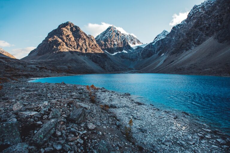 Long shadows stretch across Blåisvatnet in the Lyngen Alps, as fresh snow settles on the peaks — autumn is definitely on its way © Petr Pavlíček / Visit Lyngenfjord